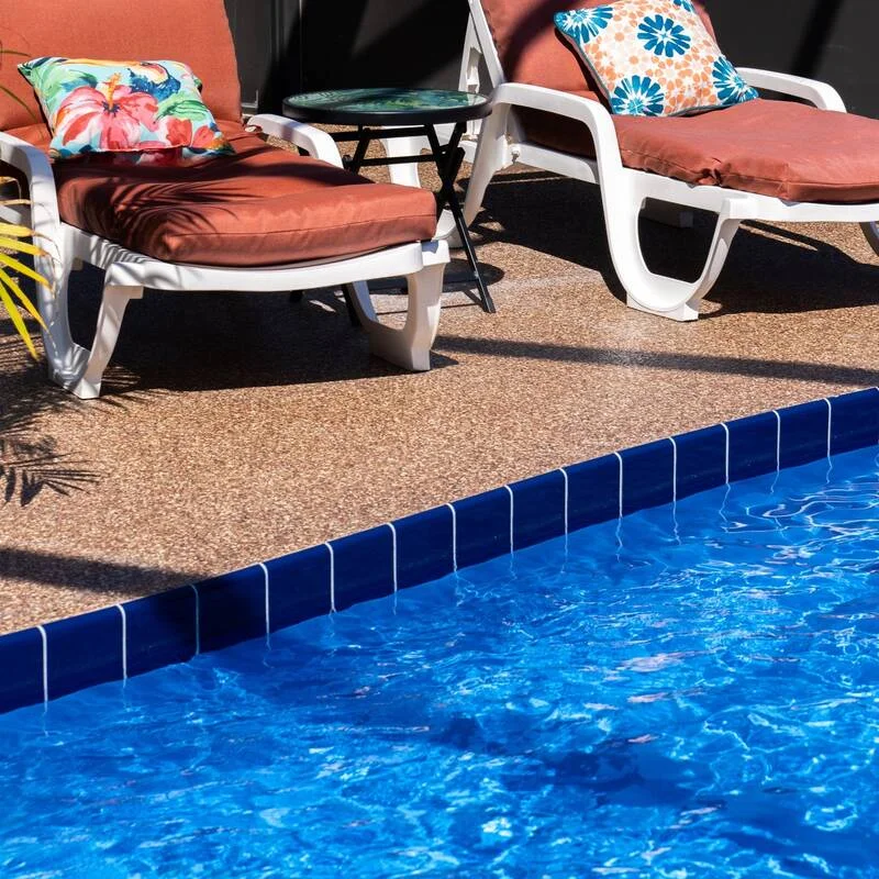 Slip-resistant flake pool deck coating around a Maui swimming pool by Innovative Coatings